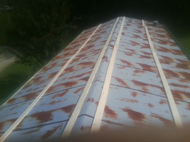 Rusted metal roof panels with new wood purlins before replacement — Storm Damage Roof Repair in Delphi by Roofing Brothers